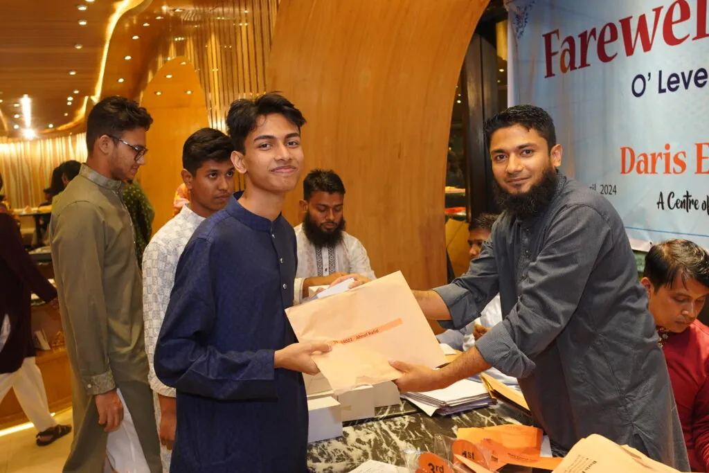 Mahamud Sir presenting gifts to an O Level candidate at the Daris farewell